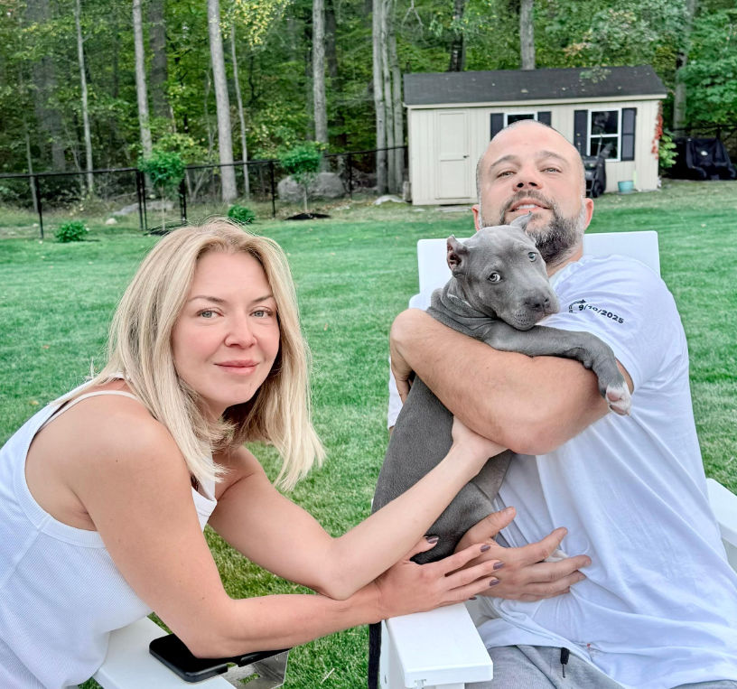 Showtime Bullies customer holding his XL American Bully dog, sharing a positive testimonial about the breeder