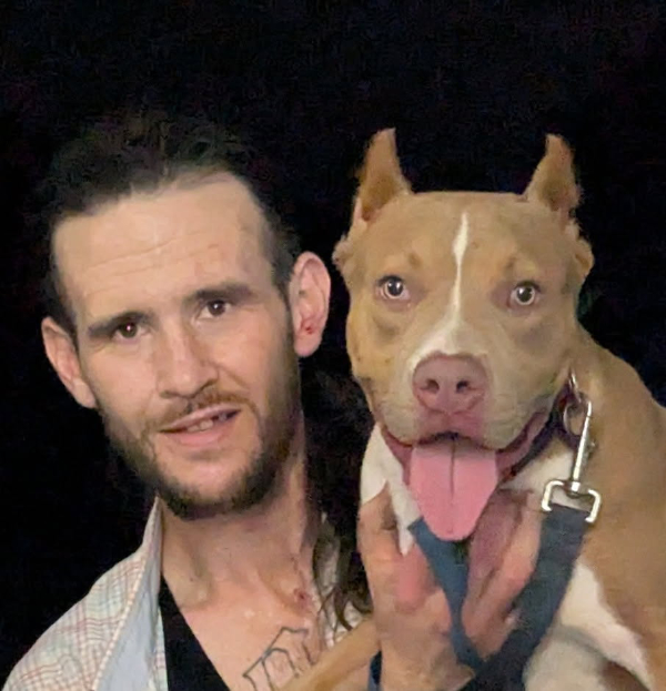 Richard Pomeroy Showtime Bullies customer holding his XL American Bully dog, sharing a positive testimonial about the breeder